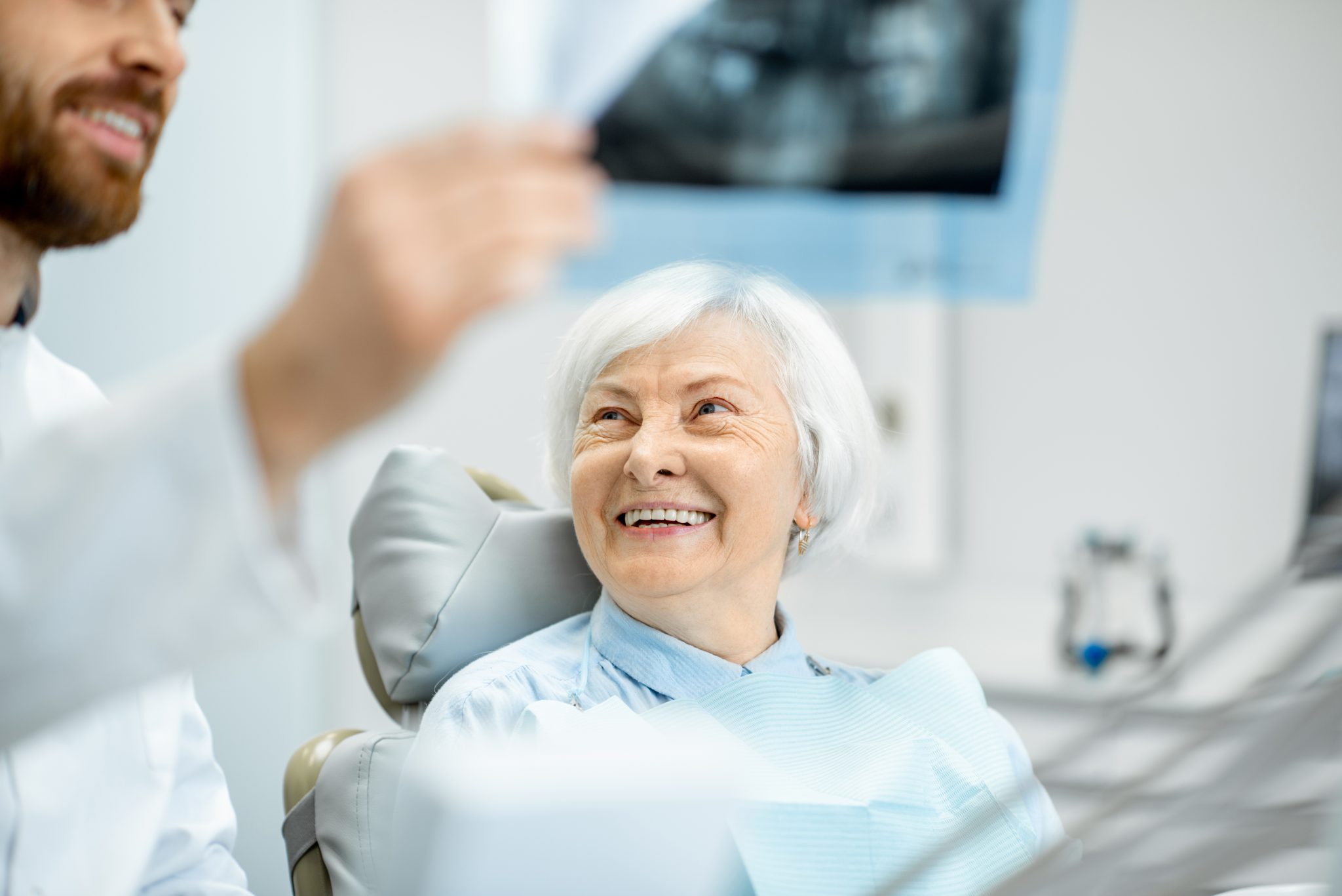 Elderly Woman Smiling At A Dentist